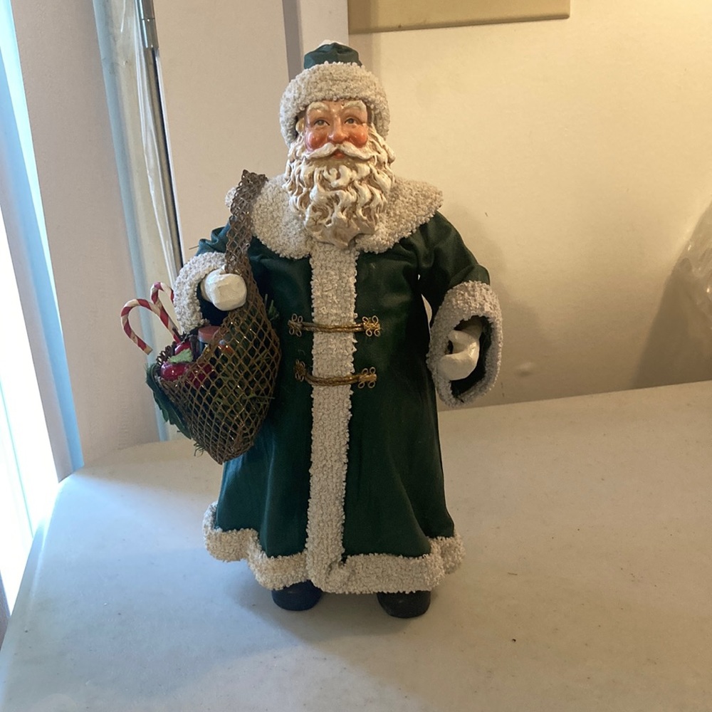 1993 Clothtique by Possible Dreams Santa carrying Goidy Bag